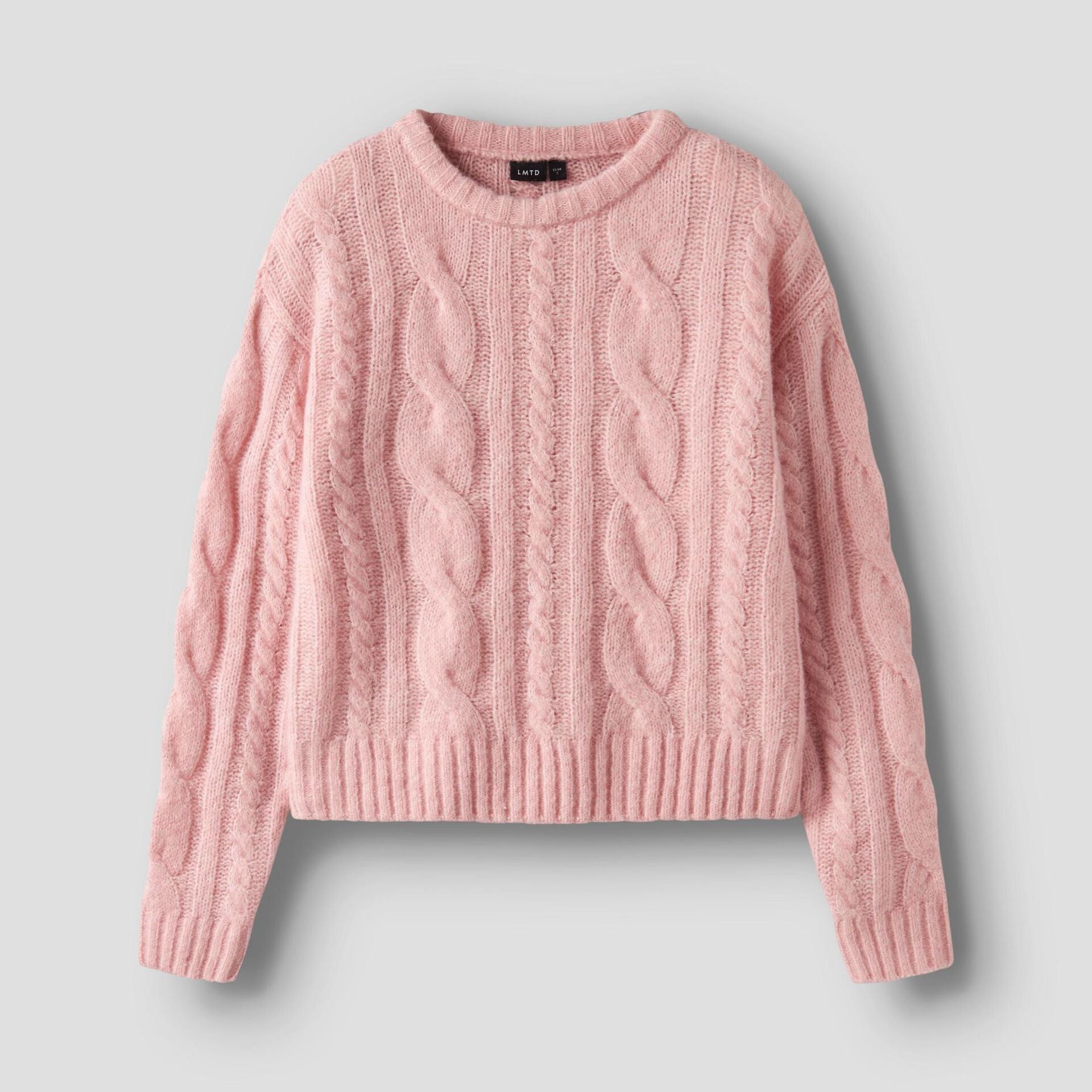 Pink cable knit sweater on a light gray background