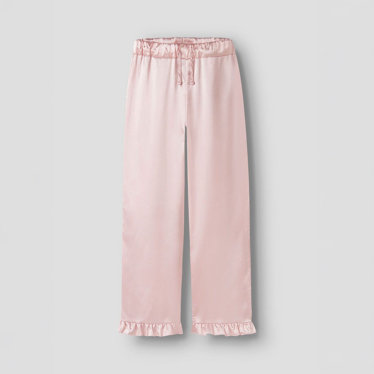 Pink satin pajama pants with ruffle hem on a light gray background