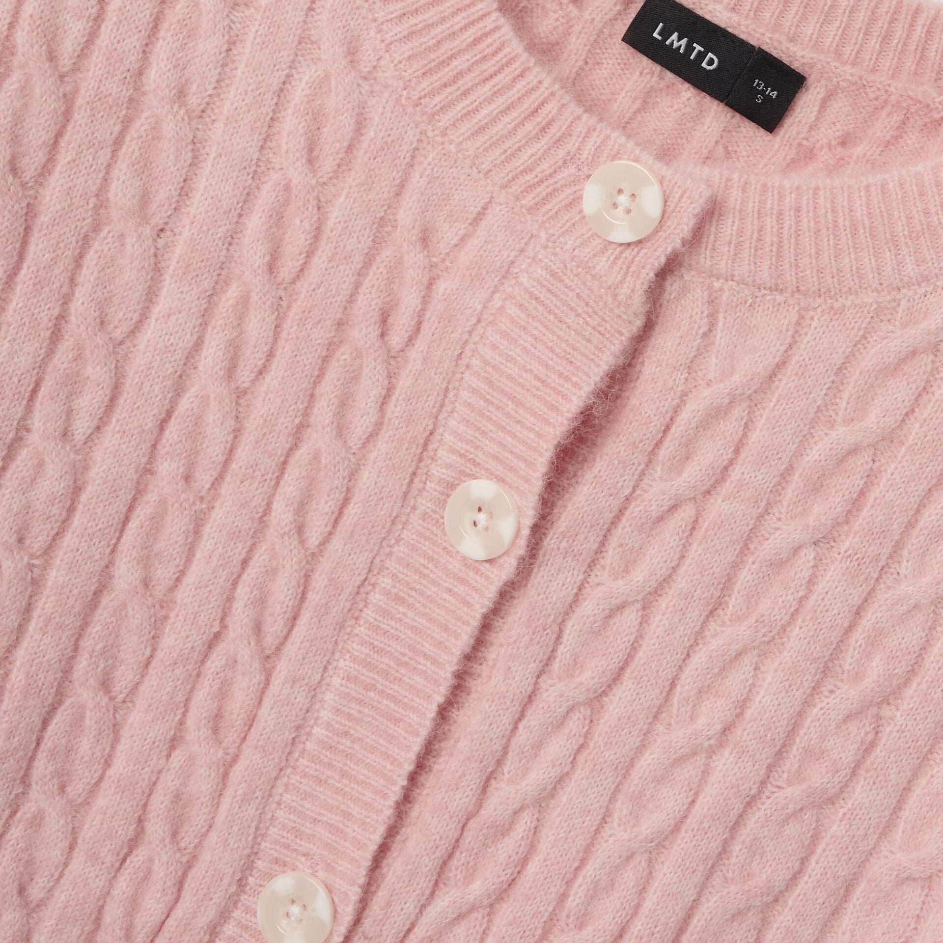 Close-up of a pink cable knit cardigan with button details and 'LMTD' label.
