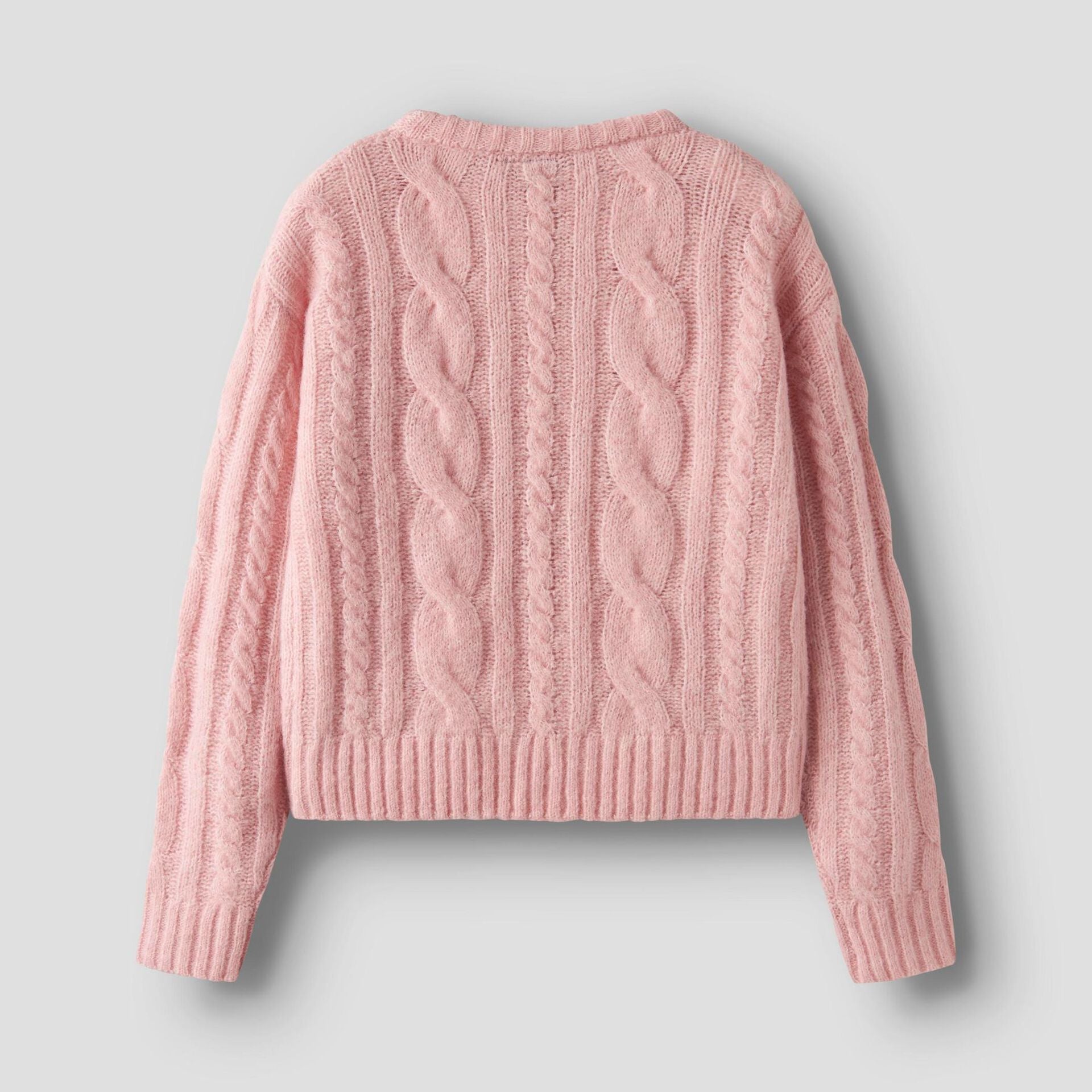 Pink cable knit sweater on a light gray background