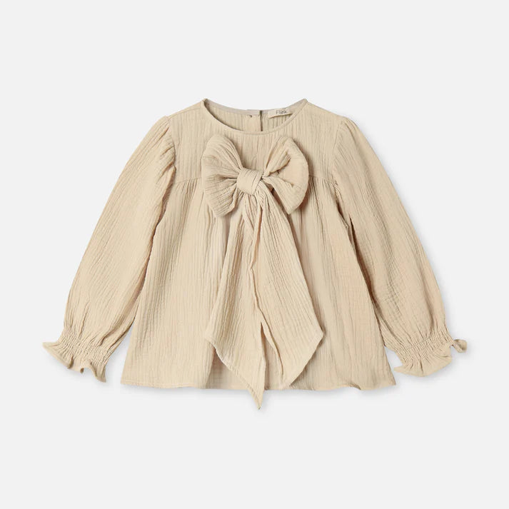 Beige blouse with a large bow on a white background