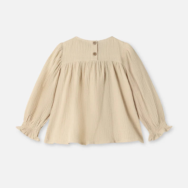 Beige blouse with long sleeves on a white background